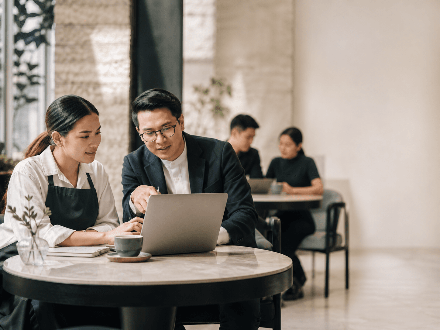 A business owner and consultant reviewing an enrolment plan